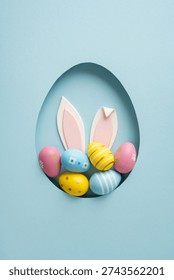 Happy Easter vertical greeting featuring bunny ears and colorful pastel eggs nestled in an egg-shaped paper cutout for spring celebration and holiday decor