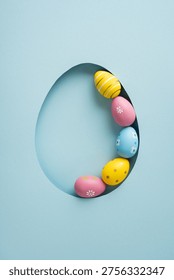Happy Easter vertical greeting featuring pastel decorated eggs arranged in a paper egg-shaped cutout, evoking spring celebration and colorful minimal holiday design for cards and social media