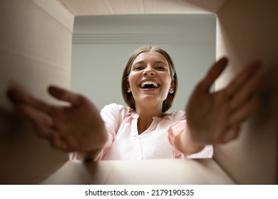 Happy e-commerce client, young woman feels overjoyed getting long-awaited parcel with goods smile looks at camera, close up view from bottom of box. Comfort shipping services, orders at home concept - Shutterstock ID 2179190535