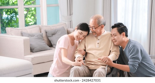 Happy elder Asian man using wheelchair while exercise indoor house with his son taking care of him at the retirement age with copy space - Powered by Shutterstock