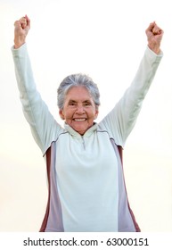 Happy Elder Woman With Arms Up And Smiling