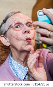 Happy Elder Woman Taking Duck Face Selfie