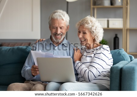 Similar – Image, Stock Photo Smiling couple using gadgets while spending time together