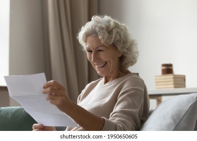 Happy Elderly 60s Excited About Good News, Reading Paper Mail Letter In Living Room. Senior Woman Receiving Bank Notice About Loan Or Savings, Income From Investment, Getting Post Correspondence