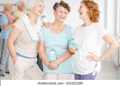 Happy Elderly Active Girlfriends Gossiping In A Gym