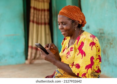 happy elderly african woman using her mobile phone - Shutterstock ID 2127932642