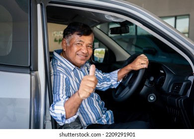 Happy Elderly Asian Man Showing Thumb Up In New Car.