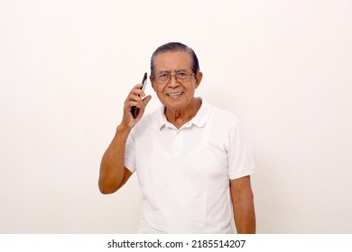 Happy Elderly Asian Man Standing While Talking On The Phone. Isolated On White Background