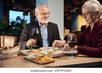 Happy elderly couple celebrating New Years Eve in restaurant - Powered by Shutterstock