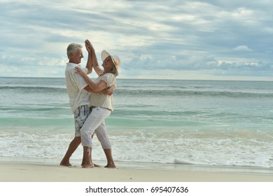 Happy Elderly  Couple  Dancing  On  Tropical Beach