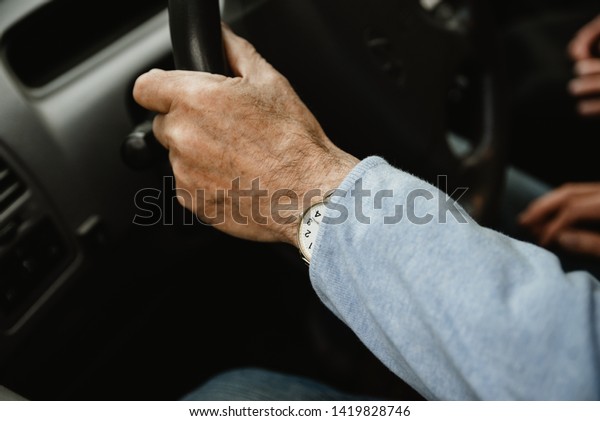 Happy elderly couple\
inside modern car. Seniors travelling together in car. Smiled and\
active retirees having date and romance inside new car. Happy aged\
family concept