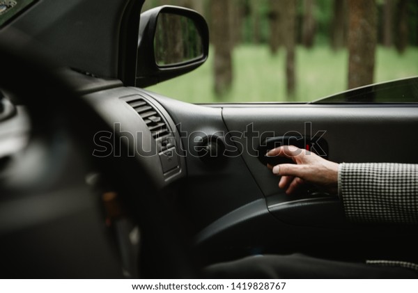 Happy elderly couple\
inside modern car. Seniors travelling together in car. Smiled and\
active retirees having date and romance inside new car. Happy aged\
family concept