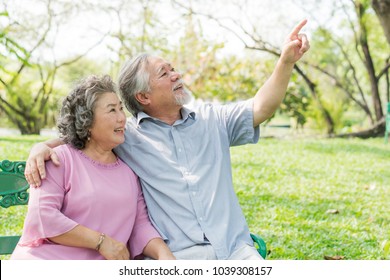 Happy Elderly Couple With Lifestyle After Retiree Concept. Lovely Asian Seniors Couple Embracing Together In The Park In The Morning.