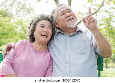 Happy Elderly Couple With Lifestyle After Retiree Concept. Lovely Asian Seniors Couple Embracing Together In The Park In The Morning.