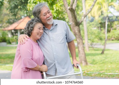 Happy Elderly Couple With Lifestyle After Retiree Concept. Lovely Asian Seniors Couple Embracing Together In The Park In The Morning.