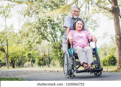 Happy Elderly Couple With Lifestyle After Retiree Concept. Lovely Asian Seniors Couple Embracing Together In The Park In The Morning.