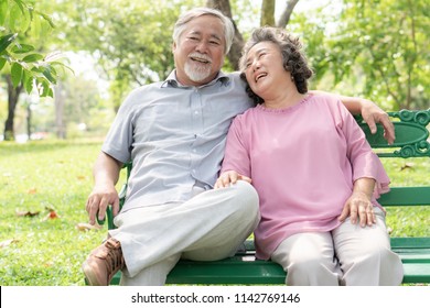 Happy Elderly Couple With Lifestyle After Retiree Concept. Lovely Asian Seniors Couple Embracing Together In The Park In The Morning.