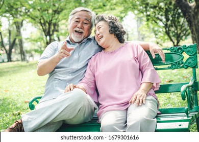 Happy Elderly Couple With Lifestyle After Retiree Concept. Lovely Asian Seniors Couple Embracing Together In The Park In The Morning.