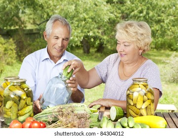 Happy Elderly Couple Making Home Made Pickles