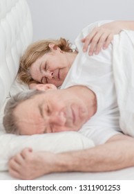 Happy Elderly Couple Sleeping Together On The Bed