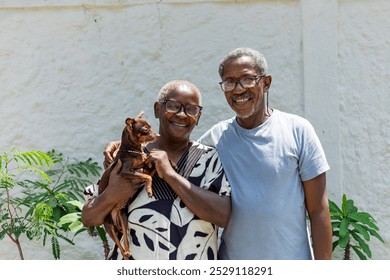 Happy elderly couple smiling on a light background. Couple with their dog, couple smiling. African couple. Black. - Powered by Shutterstock