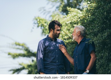 The happy elderly father and son spent time togerther with smiliing, laughing and talking at cozy home garden. Concept of freindly family - Powered by Shutterstock