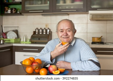 Happy Elderly Man Eating Fruit