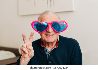 Happy Elderly Man Portrait With Heart Shaped Glasses At Home, Love Concept