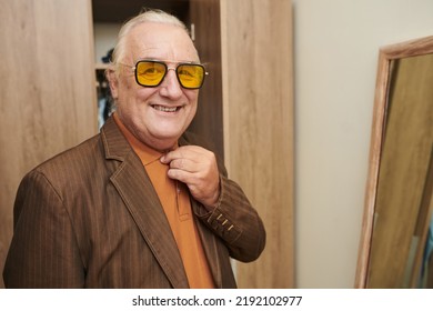 Happy Elderly Man Wearing Yellow Sunglasses When Getting Ready For A Date