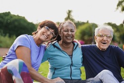 Happy Elderly People Having Fun Hugging Each Other Outdoor After Yoga Lesson