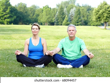 Happy elderly senior couple doing yoga