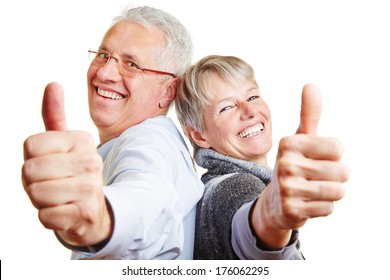 Happy elderly senior couple holding their thumbs up