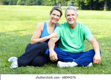 Happy elderly senior couple relaxing in the park