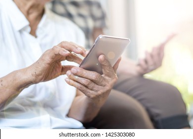 Happy Elderly Senior People Society Lifestyle Technology Concept. Ageing Asia Women Using Tablet Smartphone Or Mobile Phone Share Social Media Together In Wellbeing County Home. 