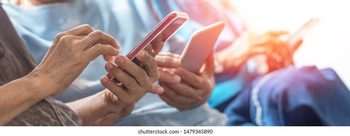 Happy elderly senior people society lifestyle technology concept. Ageing Asia women using tablet smartphone or mobile phone share social media together in wellbeing county home. 