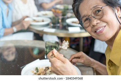 Happy Elderly Senior People Society Family Lifestyle Concept. Ageing Asia Women And Man Having Dinner On Dining Table Together In Hospice Older Wellbeing Nursing Home Community.