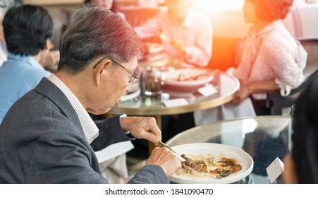 Happy Elderly Senior People Society Family Lifestyle Concept. Ageing Asia Women And Man Having Dinner On Dining Table Together In Hospice Older Wellbeing Nursing Home Community.