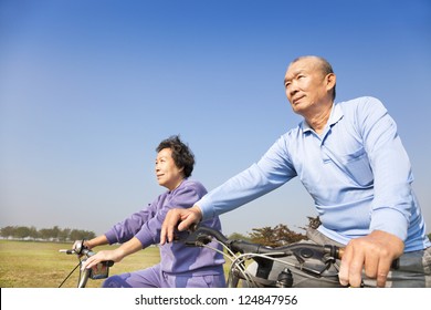 Happy Elderly Seniors Couple Biking