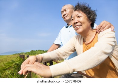 Happy Elderly Seniors Couple In The Park