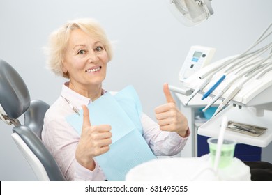 Happy elderly woman smiling showing thumbs up sitting at the dentist office after dental examination copyspace happiness client patient service healthy healthcare medicine insurance trust satisfaction