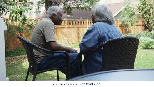 Happy Eldery Black Couple Talking In The Backyard