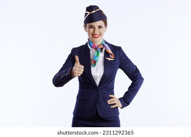 happy elegant female air hostess against white background in uniform showing thumbs up.