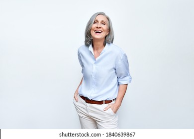 Happy elegant mature senior business woman laughing standing isolated on grey background. Smiling confident cheerful middle aged 60s lady with dental white smile looking at camera, copy space. - Shutterstock ID 1840639867
