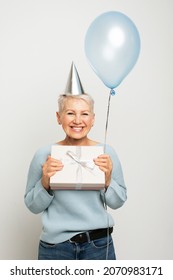 Happy Elegant Mature Woman With Balloon And Giftbox