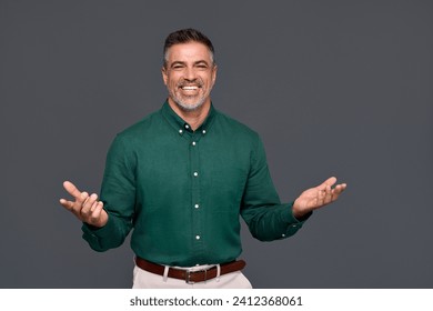 Happy elegant middle aged business man entrepreneur, smiling cheerful older professional stylish businessman wearing green shirt presenting ads standing isolated on gray background. - Powered by Shutterstock