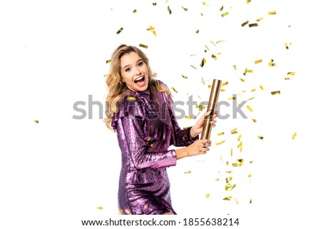 happy elegant woman in sequin dress with Party popper under falling confetti isolated on white