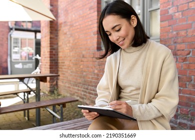 Happy Elegant Young Business Woman Entrepreneur, Small Business Owner Or Retail Professional Manager Or Student Holding Using Digital Tablet Pad Applications Technology Sitting Outside.