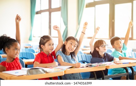 Happy Elementary School Kids  In Classroom