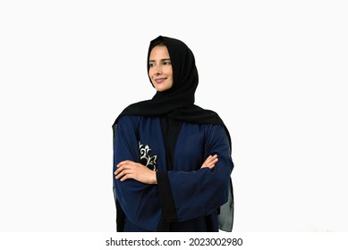 Happy Emarati women wearing Abaya doing cross arm looking far.  UAE girl in Hijab hair veil as part of cultural outfit. 