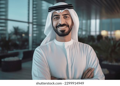 Happy Emirati Arab at office wearing Kandura looking at front ideal for Middle East business concept - Shutterstock ID 2299914949